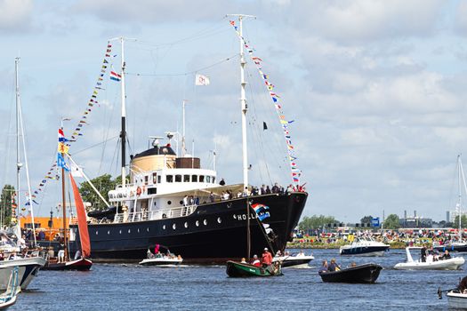 SAIL AMSTERDAM 2010 -IJMUIDEN, THE NETHERLANDS - AUGUST 2010: Sail 2010 starts with the spectaculair Sail-in Parade.  50 Tall ships and more than 500 of  naval ships, replicas and yachts sail in convoy through the North Sea Canal from IJmuiden to Amsterdam. Thousands of private boats accompany the fleet and more than 300.000 visitors watch the parade from the banks. August 19, 2010, IJmuiden, the Netherlands