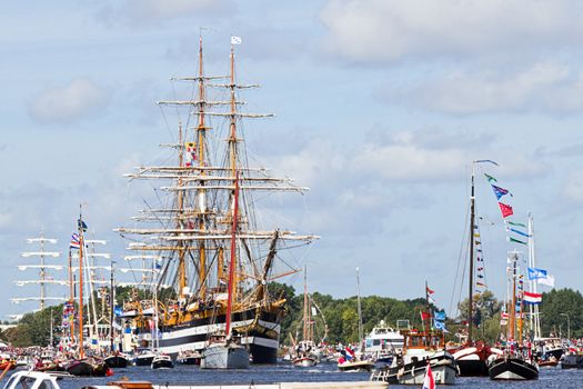 SAIL AMSTERDAM 2010 -IJMUIDEN, THE NETHERLANDS - AUGUST 2010: Sail 2010 starts with the spectaculair Sail-in Parade.  50 Tall ships and more than 500 of  naval ships, replicas and yachts sail in convoy through the North Sea Canal from IJmuiden to Amsterdam. Thousands of private boats accompany the fleet and more than 300.000 visitors watch the parade from the banks. August 19, 2010, IJmuiden, the Netherlands