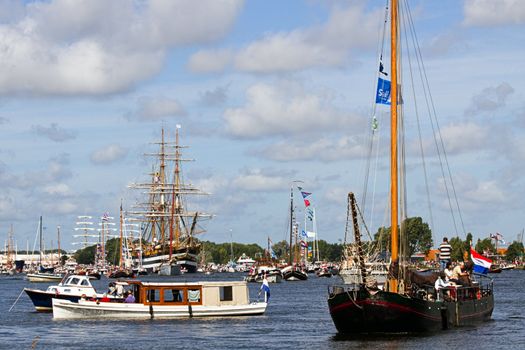 SAIL AMSTERDAM 2010 -IJMUIDEN, THE NETHERLANDS - AUGUST 2010: Sail 2010 starts with the spectaculair Sail-in Parade.  50 Tall ships and more than 500 of  naval ships, replicas and yachts sail in convoy through the North Sea Canal from IJmuiden to Amsterdam. Thousands of private boats accompany the fleet and more than 300.000 visitors watch the parade from the banks. August 19, 2010, IJmuiden, the Netherlands