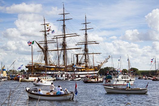 SAIL AMSTERDAM 2010 -IJMUIDEN, THE NETHERLANDS - AUGUST 2010: Sail 2010 starts with the spectaculair Sail-in Parade.  50 Tall ships and more than 500 of  naval ships, replicas and yachts sail in convoy through the North Sea Canal from IJmuiden to Amsterdam. Thousands of private boats accompany the fleet and more than 300.000 visitors watch the parade from the banks. August 19, 2010, IJmuiden, the Netherlands