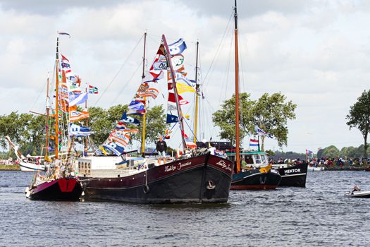 SAIL AMSTERDAM 2010 -IJMUIDEN, THE NETHERLANDS - AUGUST 2010: Sail 2010 starts with the spectaculair Sail-in Parade.  50 Tall ships and more than 500 of  naval ships, replicas and yachts sail in convoy through the North Sea Canal from IJmuiden to Amsterdam. Thousands of private boats accompany the fleet and more than 300.000 visitors watch the parade from the banks. August 19, 2010, IJmuiden, the Netherlands