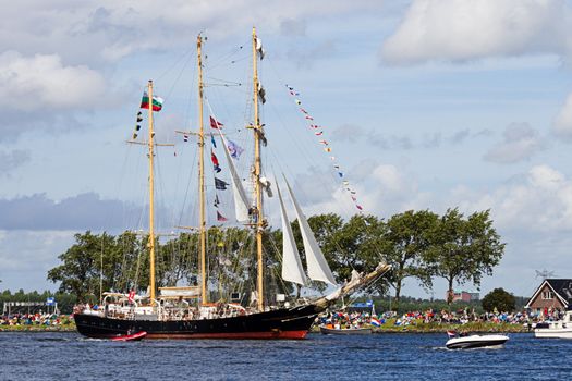 SAIL AMSTERDAM 2010 -IJMUIDEN, THE NETHERLANDS - AUGUST 2010: Sail 2010 starts with the spectaculair Sail-in Parade.  50 Tall ships and more than 500 of  naval ships, replicas and yachts sail in convoy through the North Sea Canal from IJmuiden to Amsterdam. Thousands of private boats accompany the fleet and more than 300.000 visitors watch the parade from the banks. August 19, 2010, IJmuiden, the Netherlands