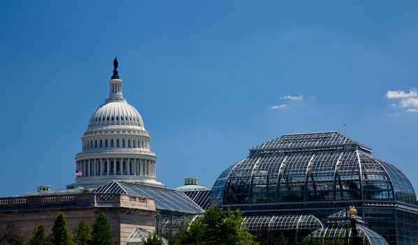 The Capitol building in Washington DC framed by US Botanic Gardens Conservatory