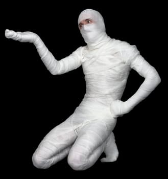 Mummy with extended hand sitting on black