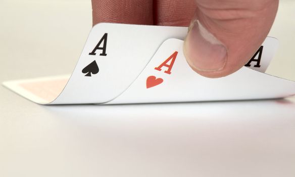 The ace of hearts and ace of spades on hand