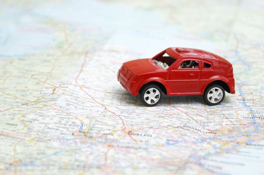 A toy car is driving on a map.