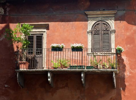 Ancient orange or ochre balcony in Verona