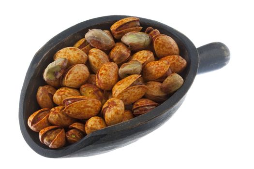 chili lemon roasted pistachio nuts on a rustic, wooden scoop, isolated on white
