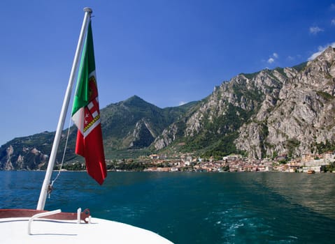 Italian flag on ferry leaving Limone on Lake Garda