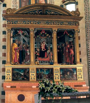 Altar in San Zeno church in Verona showing ornate paintings and carvings