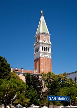 San Marco bell tower rises above the trees in Venice