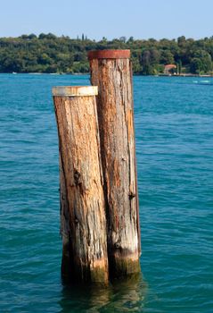 Wood mooring posts in Lake Garda in Italy