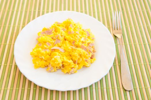 Scrambled eggs on the white plate