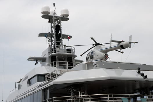 Helicopter on a big yacht with a cloudy sky