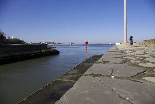 It's a nice view of a little harbour with lovers kissing.