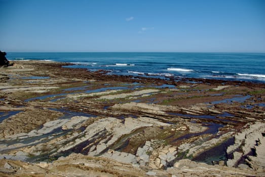 A view at low tide on the rocky Atlantic coast in Saint Jean de Luz in France, in the Basque Country