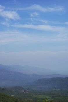 This is a landscape view in the little montains on Bali island, with some morning fog