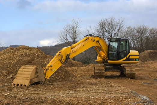 It's a side view of a yellow mechanical shovel