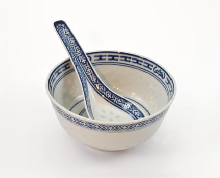 Asian ceramic small dish with a spoon on a white background