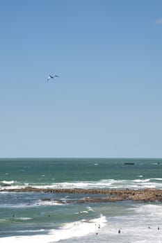 Blue and white kite in a blue sky above french Atlantic coast