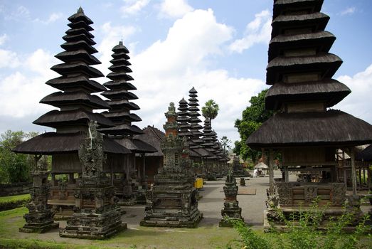 This is a temple in Bali island with many typical pointed black roofs. The number of roofs depend of the type of god