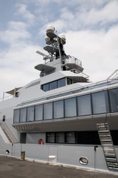 Middle part of a big yacht with a cloudy sky