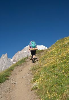 hiker in action with Mont Blanc on background