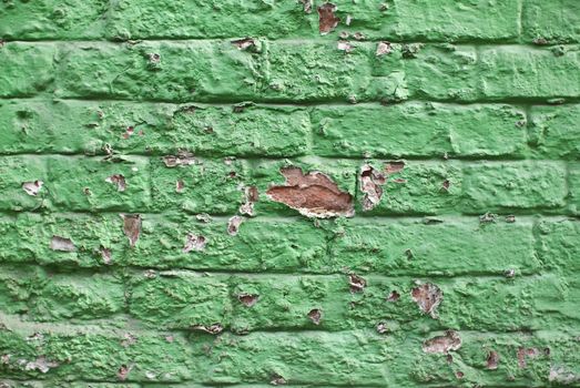 a close-up of an old aged green colored brickwall