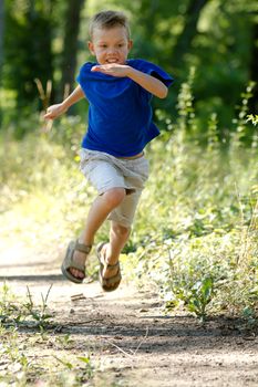 Young boy running in nature