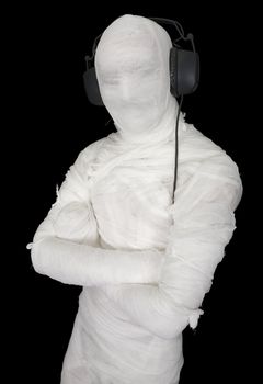 Man in bandage with ear-phones on black