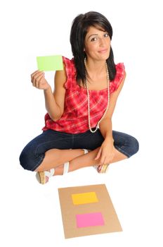 attractive hispanic woman holding bright index cards on a white background