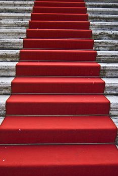 dirty red carpet leading up a staircase