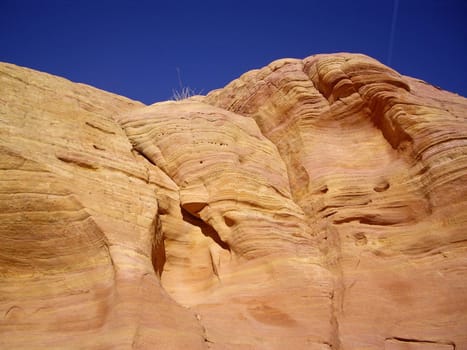 Smooth sandstone cliff with striated colors