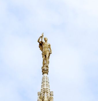 Statue on top of a "guglia" of Duomo of Milano, one of the most important monuments of christianity