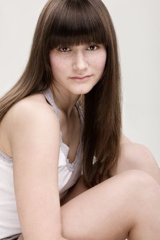 Desaturated portrait of young beautiful girl with freckles