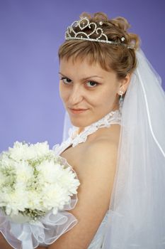 Portrait of the beautiful young woman - the bride on violet background