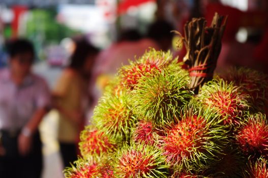 rambutans, asia exotic fruits on sale at street.