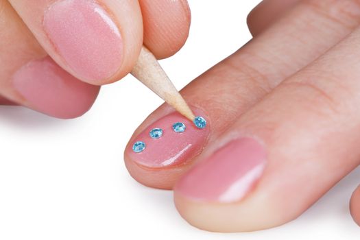 Close up - gluing a paste on nails, isolated on white background
