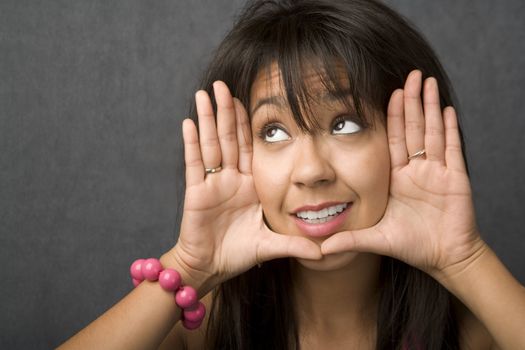 Beautiful young woman framing her face with hands