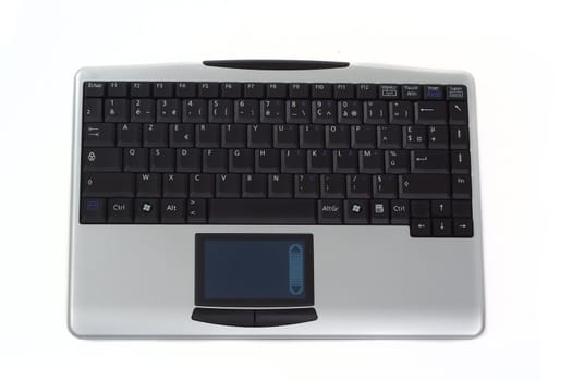 Straight view of grey wireless keyboard with touchpad, isolated over white background