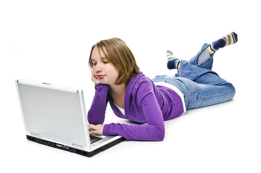 Young girl lying down with laptop computer