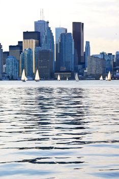 Toronto harbor skyline with skyscrapers and sailboat