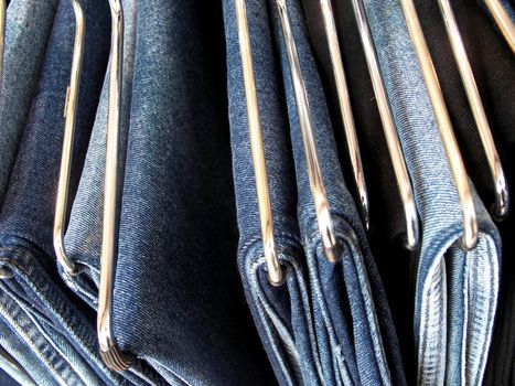 A rack full of hanging jeans.