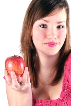 Teenage girl holding an apple on a white background.