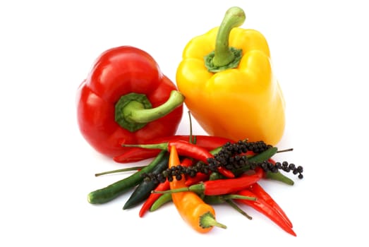 Paprika and different kinds of pepper on white background.