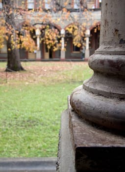 Column with peeling paint and rust overlooking courtyard