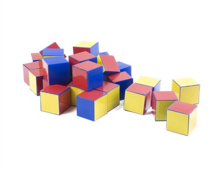 small heap of color plastic bricks toys on white