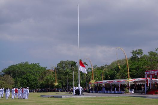 Indonesian national flag being hoisted on Independence day. Renon Park, Denpasar, Bali, Indonesia. August 17, 2010