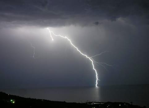 Night thunderstorm and calm sea