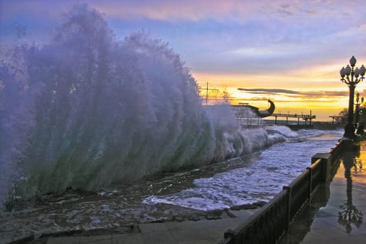 Beautiful wave and a seafront at sunset